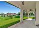 Covered patio with ceiling fans, overlooking a grassy backyard at 5494 Mojave Ave, North Port, FL 34288