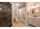 Bathroom with shower, toilet, vanity, and decorative tile at 213 75Th St, Holmes Beach, FL 34217