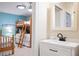 Bathroom with vanity and view into bedroom with bunk beds at 213 75Th St, Holmes Beach, FL 34217