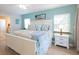 Main bedroom with a king-size bed, light wood furniture, and a ceiling fan at 213 75Th St, Holmes Beach, FL 34217