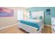 Bedroom with queen bed, light wood floors, and coastal decor at 213 75Th St, Holmes Beach, FL 34217