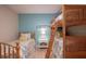 Bedroom with twin bed and bunk bed, light wood floors, and coastal decor at 213 75Th St, Holmes Beach, FL 34217