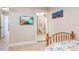 Bedroom with a twin bed, en-suite bathroom, and light wood floors at 213 75Th St, Holmes Beach, FL 34217