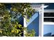 Charming front entrance with blue door and arbor at 213 75Th St, Holmes Beach, FL 34217