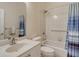 Bright bathroom featuring a shower-tub combo with tile surround and a white single sink vanity at 4072 Fairway Pl, North Port, FL 34287