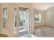 Home entryway leads to a bright living space with tile flooring and a view of the front porch at 4072 Fairway Pl, North Port, FL 34287