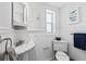 Small bathroom with white pedestal sink and toilet at 4108 101St W St, Bradenton, FL 34210