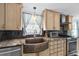 Modern kitchen with stainless steel appliances and copper farmhouse sink at 4108 101St W St, Bradenton, FL 34210