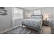 Guest bedroom with gray wood bed frame and coastal decor at 4108 101St W St, Bradenton, FL 34210