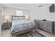 Guest bedroom with gray wood bed frame and coastal decor at 4108 101St W St, Bradenton, FL 34210