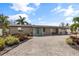 Single-story home with teal door and gravel driveway at 4108 101St W St, Bradenton, FL 34210