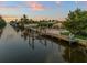 Stunning waterfront view of canal with private dock and reflection of home at sunset at 4108 101St W St, Bradenton, FL 34210