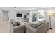 Bright living room with comfy sofas, large TV, and sliding glass doors leading to the backyard at 4108 101St W St, Bradenton, FL 34210