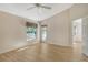 Bedroom with wood-look floors, backyard access, and ceiling fan at 4072 Fairway Pl, North Port, FL 34287