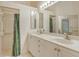 Bathroom with double vanity, large mirror, and walk-in shower at 4072 Fairway Pl, North Port, FL 34287