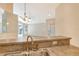 Kitchen sink with view into living room and backyard at 4072 Fairway Pl, North Port, FL 34287