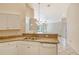 Kitchen with double sink and view into living room at 4072 Fairway Pl, North Port, FL 34287