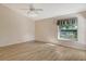 Bright bedroom with vaulted ceiling, wood-look floors, and access to backyard at 4072 Fairway Pl, North Port, FL 34287