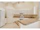 White kitchen with ample cabinetry and corian countertops at 4072 Fairway Pl, North Port, FL 34287