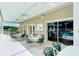 Relaxing poolside patio with tables and chairs for lounging at 4072 Fairway Pl, North Port, FL 34287