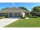 House exterior featuring a two-car garage and well-maintained landscaping at 4072 Fairway Pl, North Port, FL 34287