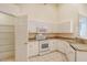 White kitchen with pantry and stainless steel appliances at 4072 Fairway Pl, North Port, FL 34287