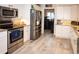 Modern kitchen with stainless steel appliances and granite countertops at 6772 Greenview Ln, Englewood, FL 34224