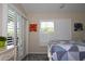 Bedroom with sliding door leading to patio, window with shutters, and a comfy bed at 6772 Greenview Ln, Englewood, FL 34224