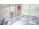 Bedroom with sliding door leading to patio, window with shutters, and a comfy bed at 6772 Greenview Ln, Englewood, FL 34224
