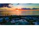 Stunning sunset over marina, waterfront homes, and boats at 6772 Greenview Ln, Englewood, FL 34224