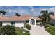 Single-story home with tile roof, landscaping, and driveway at 6772 Greenview Ln, Englewood, FL 34224