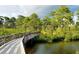 Scenic nature trail with a wooden boardwalk over water at 6772 Greenview Ln, Englewood, FL 34224