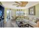 Living room with balcony access and coastal decor at 1257 S Portofino Dr # 306, Sarasota, FL 34242