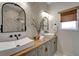 Elegant bathroom with double sinks, modern fixtures, and a textured wall at 12307 S Access Rd, Port Charlotte, FL 33981