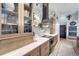 Modern kitchen boasts glass-front cabinets, custom range hood, and marble backsplash at 12307 S Access Rd, Port Charlotte, FL 33981