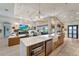 Open concept kitchen features a large island, farmhouse sink, and a view into the living room at 12307 S Access Rd, Port Charlotte, FL 33981
