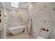 Spa-like bathroom with a freestanding tub and textured walls at 12307 S Access Rd, Port Charlotte, FL 33981