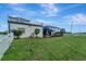 Landscaped backyard with large grassy area at 12307 S Access Rd, Port Charlotte, FL 33981