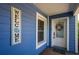Inviting exterior with a blue facade, white door, and welcome sign at 213 75Th St, Holmes Beach, FL 34217
