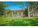 Cozy home exterior with a well-manicured lawn, complimented by mature trees, creating a serene outdoor space at 2310 Lark Ln # 22, Sarasota, FL 34231