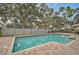 Inviting community pool with brick pavers and a surrounding fence at 3611 Chinaberry Ln, Sarasota, FL 34235