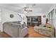 Living room with hardwood floors, sectional sofa, and a ceiling fan at 3611 Chinaberry Ln, Sarasota, FL 34235