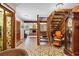 Inviting entryway with tile flooring, fireplace, and wooden staircase at 3314 65Th E St, Bradenton, FL 34208