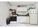 Clean kitchen featuring white cabinets and appliances at 1611 Ballard Park Dr, Bradenton, FL 34205