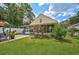 Charming yellow house exterior with a screened porch and well-manicured lawn at 3611 Chinaberry Ln, Sarasota, FL 34235