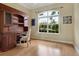 Bright home office features built-in wood desk and shelving, and large window at 6747 Coyote Ridge Ct, Bradenton, FL 34201