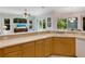 Kitchen features light wood cabinets, ample counter space, and a double sink at 6747 Coyote Ridge Ct, Bradenton, FL 34201