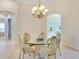 Charming dining room with glass-top table and four chairs, adjacent to kitchen at 6747 Coyote Ridge Ct, Bradenton, FL 34201