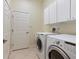 Laundry room with washer, dryer, and cabinets at 6747 Coyote Ridge Ct, Bradenton, FL 34201