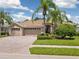 House exterior showcases attractive landscaping and two-car garage at 6747 Coyote Ridge Ct, Bradenton, FL 34201